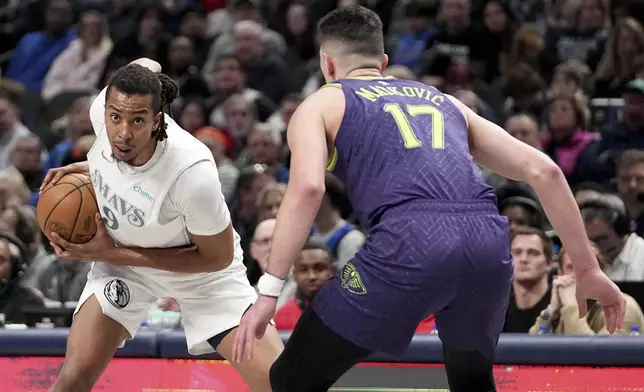 Dallas Mavericks center Moses Brown (9) looks to pass the ball as New Orleans Pelicans' Karlo Matkovic (17) defends in the first half of an NBA basketball game in Dallas, Friday, Feb. 21, 2025. (AP Photo/Tony Gutierrez)