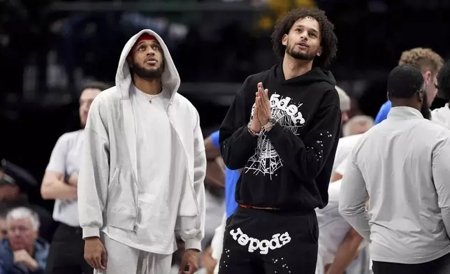 Dallas Mavericks' Daniel Gafford, left, and Dereck Lively II, right, stand on the court during a time out from play in the first half of an NBA basketball game against the New Orleans Pelicans in Dallas, Friday, Feb. 21, 2025. (AP Photo/Tony Gutierrez)