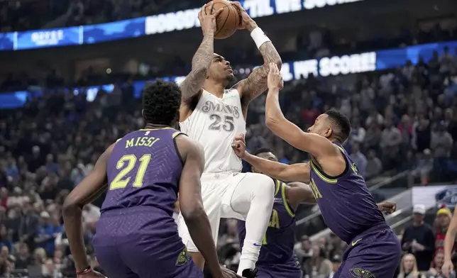 Dallas Mavericks forward P.J. Washington (25) goes up to shoot as New Orleans Pelicans' Yves Missi (21) and CJ McCollum, right, defend in the first half of an NBA basketball game in Dallas, Friday, Feb. 21, 2025. (AP Photo/Tony Gutierrez)