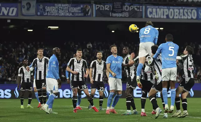 Napoli's Scott McTominay, number 8, scores on a header his side's opening goal during the Serie A soccer match between Napoli and Udinese at the Diego Armando Maradona Stadium in Naples, Italy, Sunday Feb. 9, 2025. (Alessandro Garofalo/LaPresse via AP)
