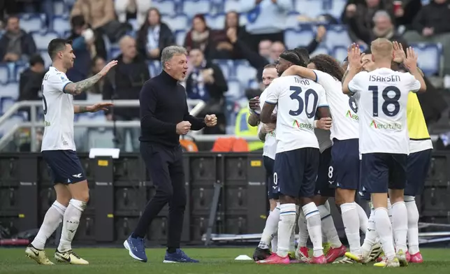 Lazio players and Lazio's head coach Marco Baroni, centre, celebrate after Lazio's Pedro scored his side's second goal during a Serie A soccer match between Lazio and Monza, at Rome's Olympic Stadium, Sunday, Feb. 9, 2025. (AP Photo/Alessandra Tarantino)
