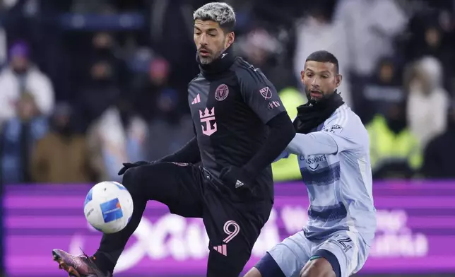 Inter Miami forward Luis Suárez (9) controls a pass as Sporting Kansas City defender Joaquín defends during the second half of a CONCACAF Champions Cup soccer match, Wednesday, Feb. 19, 2025, in Kansas City, Kan. (AP Photo/Colin E. Braley)