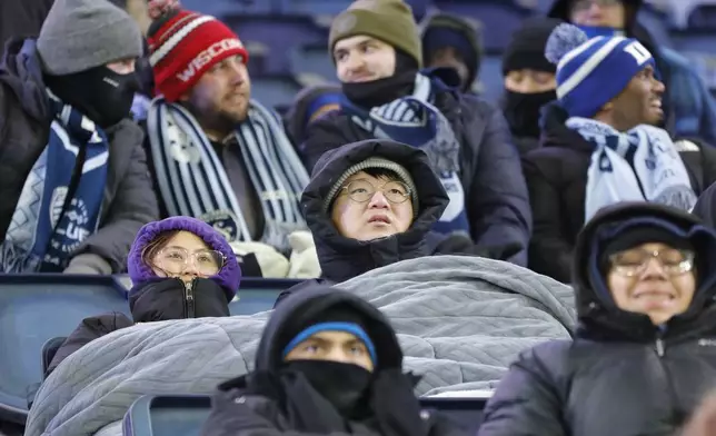 Fans brave frigid temperatures as they watch Inter Miami play Sporting Kansas City during a CONCACAF Champions Cup soccer match, Wednesday, Feb. 19, 2025, in Kansas City, Kan. (AP Photo/Colin E. Braley)