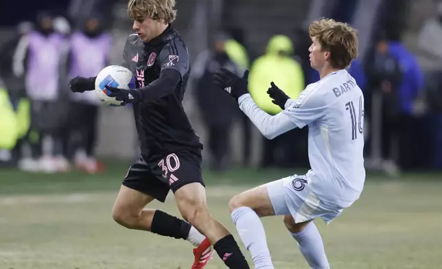 Inter Miami midfielder Benjamin Cremaschi (30) attempts to control a pass as Sporting Kansas City midfielder Jacob Bartlett (16) defends during the second half of a CONCACAF Champions Cup soccer match, Wednesday, Feb. 19, 2025, in Kansas City, Kan. (AP Photo/Colin E. Braley)