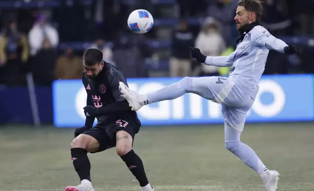 Sporting Kansas City defender Robert Voloder, right, clears the ball over Inter Miami defender Marcelo Weigandt during the first half of a CONCACAF Champions Cup soccer match, Wednesday, Feb. 19, 2025, in Kansas City, Kan. (AP Photo/Colin E. Braley)