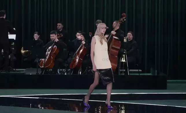 A model wears a creation as part of the Gucci Fall/Winter 2025-2026 men's and women's collection, presented in Milan, Italy, Tuesday, Feb. 25, 2025. (AP Photo/Luca Bruno)