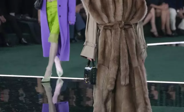 A model wears a creation as part of the Gucci Fall/Winter 2025-2026 men's and women's collection, presented in Milan, Italy, Tuesday, Feb. 25, 2025. (AP Photo/Luca Bruno)