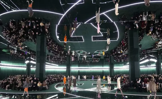 A model wears a creation as part of the Gucci Fall/Winter 2025-2026 men's and women's collection, presented in Milan, Italy, Tuesday, Feb. 25, 2025. (AP Photo/Luca Bruno)
