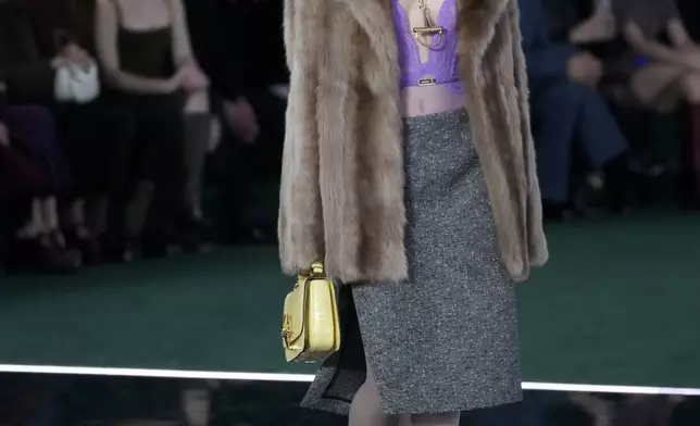 A model wears a creation as part of the Gucci Fall/Winter 2025-2026 men's and women's collection, presented in Milan, Italy, Tuesday, Feb. 25, 2025. (AP Photo/Luca Bruno)