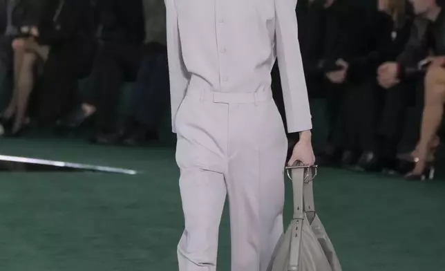 A model wears a creation as part of the Gucci Fall/Winter 2025-2026 men's and women's collection, presented in Milan, Italy, Tuesday, Feb. 25, 2025. (AP Photo/Luca Bruno)