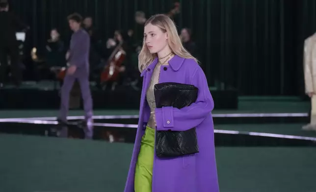 A model wears a creation as part of the Gucci Fall/Winter 2025-2026 men's and women's collection, presented in Milan, Italy, Tuesday, Feb. 25, 2025. (AP Photo/Luca Bruno)