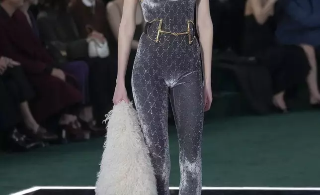 A model wears a creation as part of the Gucci Fall/Winter 2025-2026 men's and women's collection, presented in Milan, Italy, Tuesday, Feb. 25, 2025. (AP Photo/Luca Bruno)