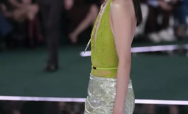 A model wears a creation as part of the Gucci Fall/Winter 2025-2026 men's and women's collection, presented in Milan, Italy, Tuesday, Feb. 25, 2025. (AP Photo/Luca Bruno)