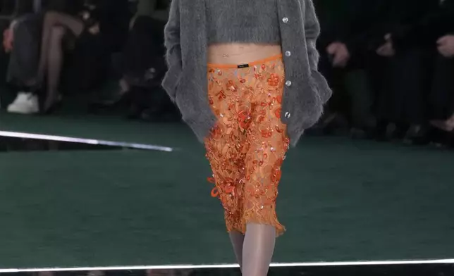 A model wears a creation as part of the Gucci Fall/Winter 2025-2026 men's and women's collection, presented in Milan, Italy, Tuesday, Feb. 25, 2025. (AP Photo/Luca Bruno)