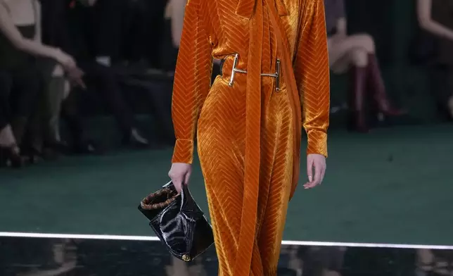 A model wears a creation as part of the Gucci Fall/Winter 2025-2026 men's and women's collection, presented in Milan, Italy, Tuesday, Feb. 25, 2025. (AP Photo/Luca Bruno)