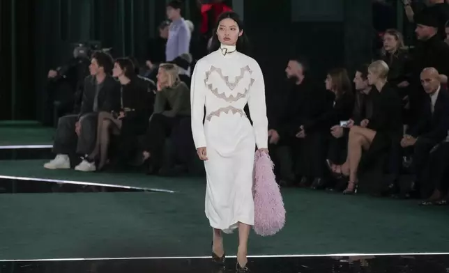 A model wears a creation as part of the Gucci Fall/Winter 2025-2026 men's and women's collection, presented in Milan, Italy, Tuesday, Feb. 25, 2025. (AP Photo/Luca Bruno)