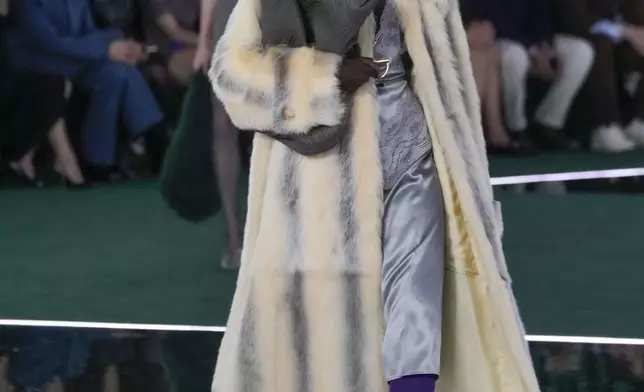 A model wears a creation as part of the Gucci Fall/Winter 2025-2026 men's and women's collection, presented in Milan, Italy, Tuesday, Feb. 25, 2025. (AP Photo/Luca Bruno)