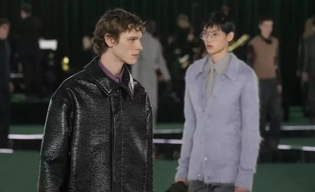 A model wears a creation as part of the Gucci Fall/Winter 2025-2026 men's and women's collection, presented in Milan, Italy, Tuesday, Feb. 25, 2025. (AP Photo/Luca Bruno)