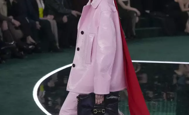 A model wears a creation as part of the Gucci Fall/Winter 2025-2026 men's and women's collection, presented in Milan, Italy, Tuesday, Feb. 25, 2025. (AP Photo/Luca Bruno)