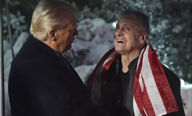 President Donald Trump greets Marc Fogel at on the South Lawn at the White House, Tuesday, Feb. 11, 2025, in Washington. (AP Photo/Evan Vucci)
