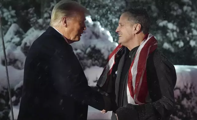 President Donald Trump greets Marc Fogel at on the South Lawn at the White House, Tuesday, Feb. 11, 2025, in Washington. (AP Photo/Evan Vucci)