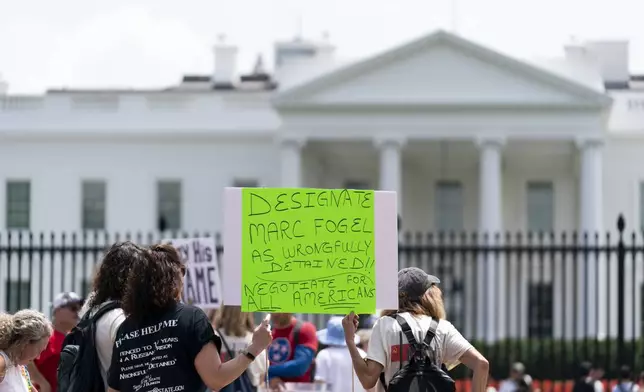 FILE - Family members, friends and colleagues of Marc Fogel, who has been detained in Russia since August 2021, rally for his release outside of the White House, July 15, 2023, in Washington. (AP Photo/Stephanie Scarbrough, File)