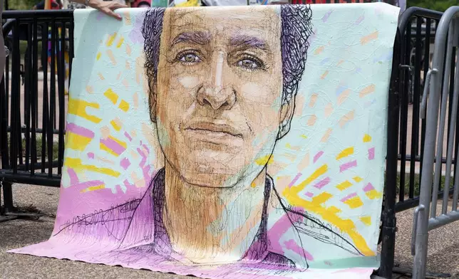 FILE - A drawn portrait of Marc Fogel, who has been detained in Russia since August 2021, hangs on rails outside of the White House during a demonstration organized by his family, July 15, 2023, in Washington. (AP Photo/Stephanie Scarbrough, File)