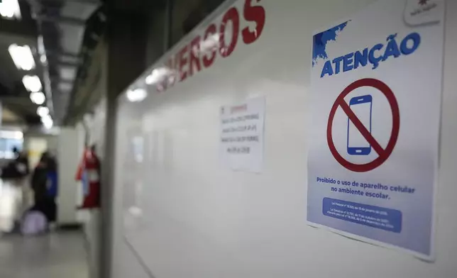 A sign reads in Portuguese " The use of cell phones in the school is prohibited" at Porto Seguro school in Sao Paulo, Thursday, Feb. 6, 2025. (AP Photo/Andre Penner)