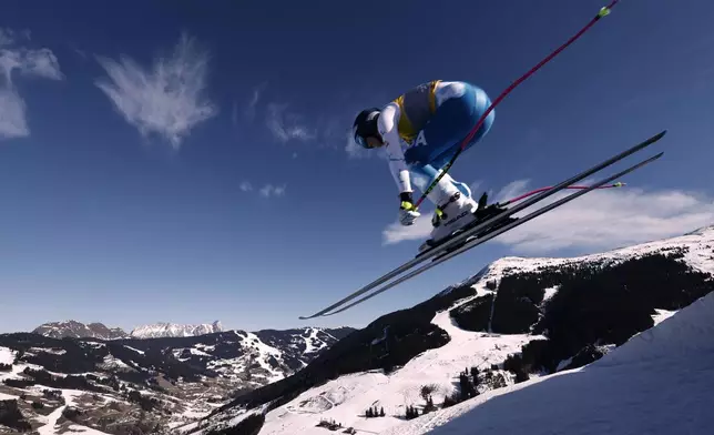 United States' Lindsey Vonn is airborne during a women's downhill race, at the Alpine Ski World Championships, in Saalbach-Hinterglemm, Austria, Saturday, Feb. 8, 2025. (AP Photo/Gabriele Facciotti)