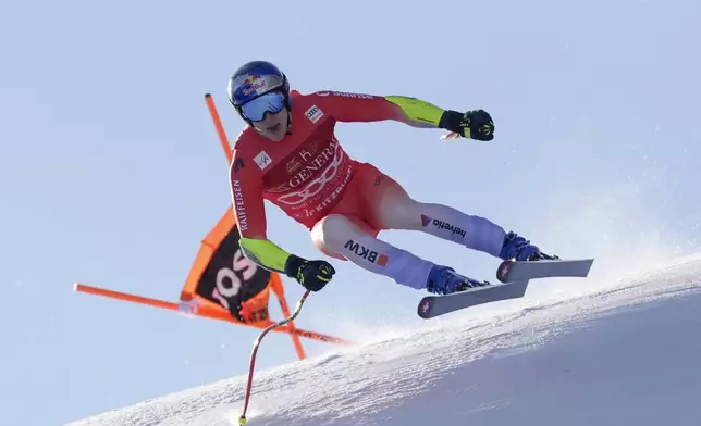 Switzerland's Marco Odermatt speeds down the course during an alpine ski, men's World Cup Super-G, in Kitzbuehel, Austria, Friday, Jan. 24, 2025. (AP Photo/Giovanni Auletta)