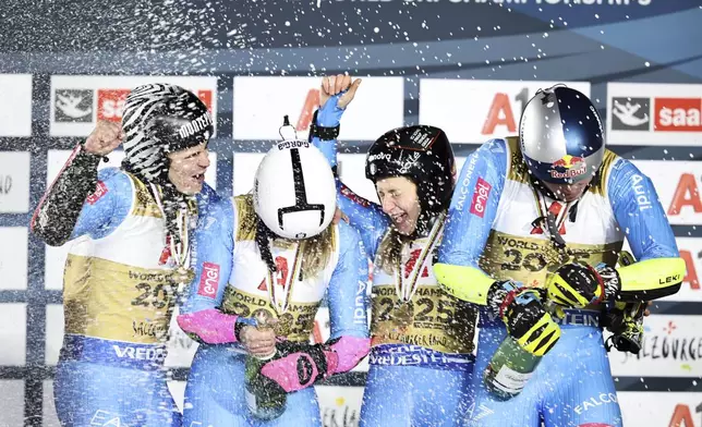 From left, Italy's Filippo Della Vite, Giorgia Collomb, Lara Della Mea and Alex Vinatzer celebrate winning the alpine ski, World Championship team parallel event, in Saalbach-Hinterglemm, Austria, Tuesday, Feb. 4, 2025. (AP Photo/Marco Trovati)