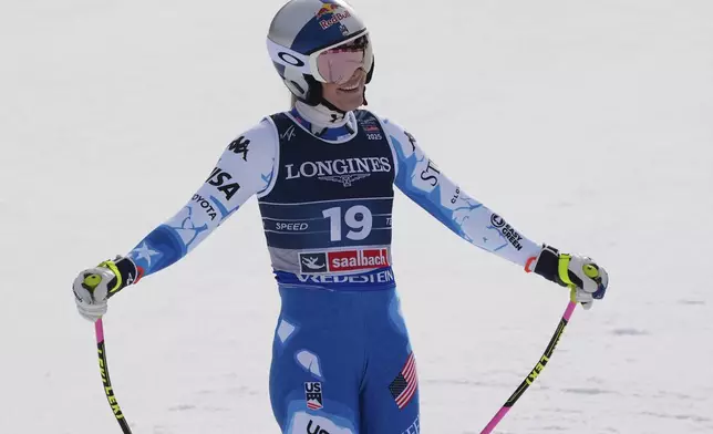 United States' Lindsey Vonn smiles at the finish area of a downhill run of a women's team combined event, at the Alpine Ski World Championships, in Saalbach-Hinterglemm, Austria, Tuesday, Feb. 11, 2025. (AP Photo/Giovanni Auletta)
