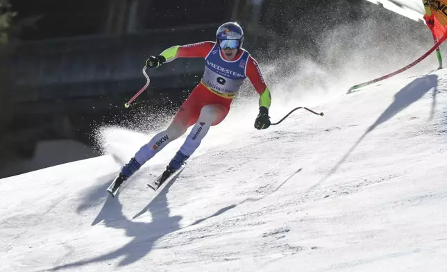 Switzerland's Marco Odermatt speeds down the course during a men's Super-G, at the Alpine Ski World Championships, in Saalbach-Hinterglemm, Austria, Friday, Feb. 7, 2025. (AP Photo/Marco Trovati)