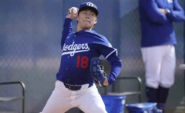 Los Angeles Dodgers pitcher Yoshinobu Yamamoto, of Japan, throws during a pitching session at the Dodgers baseball spring training facility, Tuesday, Feb. 11, 2025, in Phoenix. (AP Photo/Ross D. Franklin)