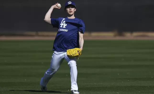 Los Angeles Dodgers pitcher Roki Sasaki, of Japan, warms up at the Dodgers baseball spring training facility, Tuesday, Feb. 11, 2025, in Phoenix. (AP Photo/Ross D. Franklin)