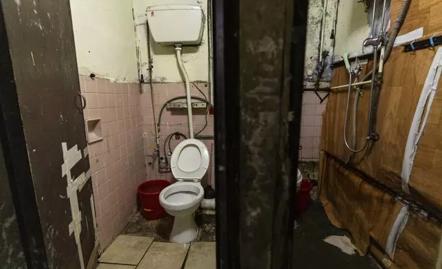 A shared toilet is seen outside a subdivided flat in the Sham Shui Po district of Hong Kong, on Feb. 6, 2025. (AP Photo/Chan Long Hei)