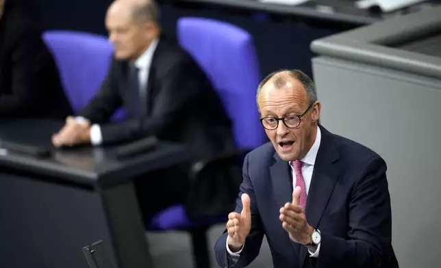 FILE - Opposition Christian Union parties floor leader Friedrich Merz, right, speaks, as German Chancellor Olaf Scholz, listens during a general debate on the budget at the German parliament Bundestag in Berlin, Germany, Wednesday, Jan. 31, 2024. (AP Photo/Ebrahim Noroozi, File)