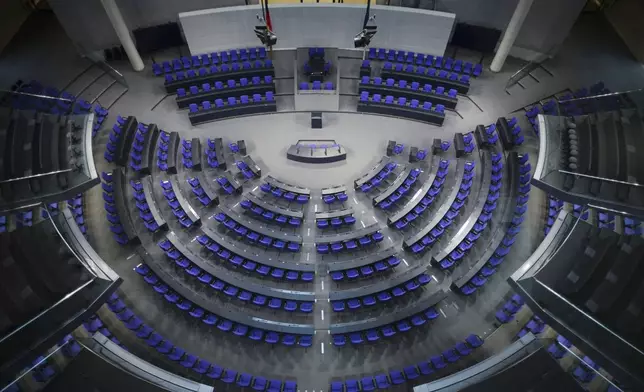 FILE - General view inside the empty plenary hall of the German parliament Bundestag at the Reichstag building in Berlin, Germany, Nov. 17, 2021. (AP Photo/Markus Schreiber, File)
