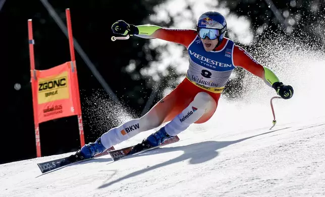 Switzerland's Marco Odermatt speeds down the course during a men's Super-G, at the Alpine Ski World Championships, in Saalbach-Hinterglemm, Austria, Friday, Feb. 7, 2025. (AP Photo/Gabriele Facciotti)