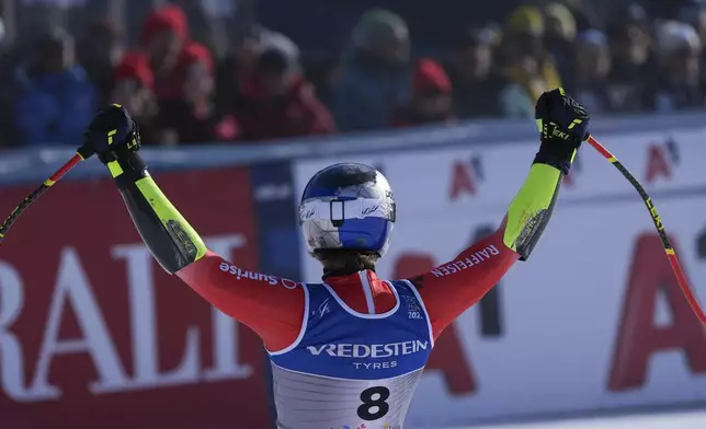 Switzerland's Marco Odermatt celebrates at the finish area of a men's Super-G, at the Alpine Ski World Championships, in Saalbach-Hinterglemm, Austria, Friday, Feb. 7, 2025. (AP Photo/Giovanni Auletta)