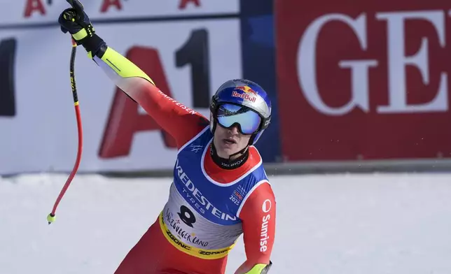 Switzerland's Marco Odermatt celebrates at the finish area of a men's Super-G, at the Alpine Ski World Championships, in Saalbach-Hinterglemm, Austria, Friday, Feb. 7, 2025. (AP Photo/Giovanni Auletta)