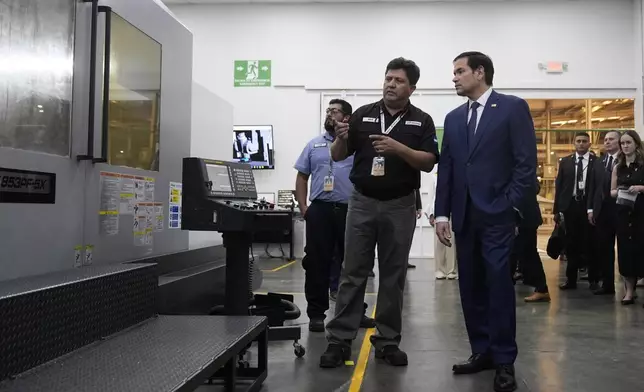 U.S. Secretary of State Marco Rubio, left, tours to the facilities of aircraft maintenance firm Aeroman in San Luis Talpa, El Salvador, Monday, Feb. 3, 2025. (AP Photo/Mark Schiefelbein, Pool)