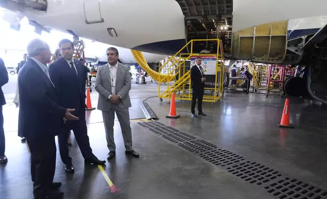 U.S. Secretary of State Marco Rubio talks to Roberto Kriete, left, during a visit to the facilities of aircraft maintenance firm Aeroman in San Luis Talpa, El Salvador, Monday, Feb. 3, 2025. (AP Photo/Mark Schiefelbein, Pool)