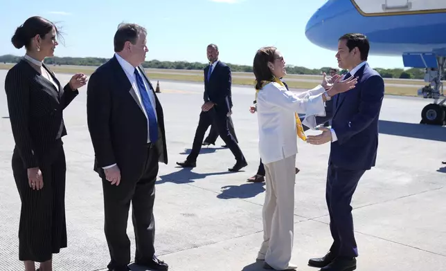 El Salvador's Foreign Minister Alexandra Hill Tinoco welcomes U.S. Secretary of State Marco Rubio, right, upon his arrival to the international airport in San Luis Talpa, El Salvador, Monday, Feb. 3, 2025. Also photographed are U.S. Ambassador to El Salvador William H. Duncan, second from left, and El Salvador Ambassador to the United States Milena Mayorga. (AP Photo/Mark Schiefelbein, Pool)