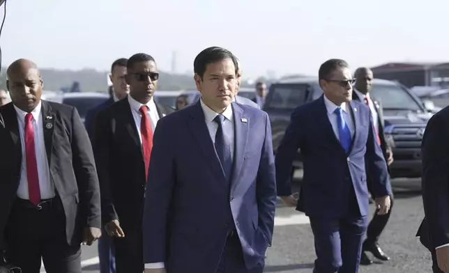 Secretary of State Marco Rubio, with Frank Alexis Abrego, Panama's Minister of Public Security, right, arrive to watch people board a repatriation flight bound for Colombia at Albrook Airport in Panama City, Monday, Feb. 3, 2025. (AP Photo/Mark Schiefelbein, Pool)