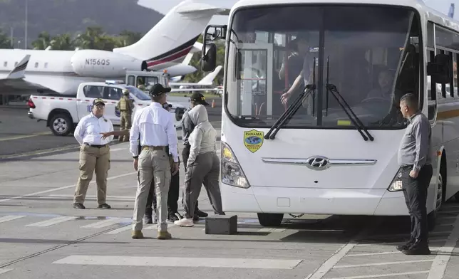 People arrive to board a repatriation flight bound for Colombia at Albrook Airport in Panama City, Monday, Feb. 3, 2025. (AP Photo/Mark Schiefelbein, Pool)