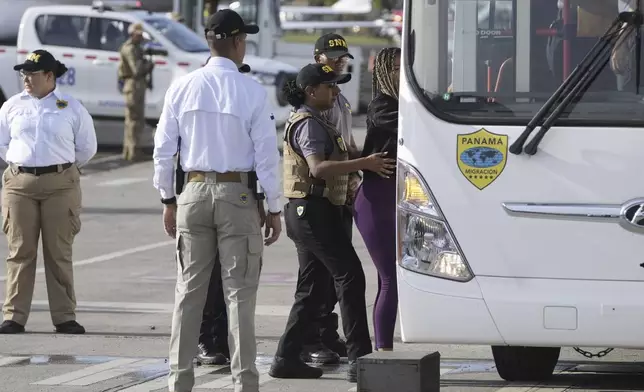People arrive to board a repatriation flight bound for Colombia at Albrook Airport in Panama City, Monday, Feb. 3, 2025. (AP Photo/Mark Schiefelbein, Pool)