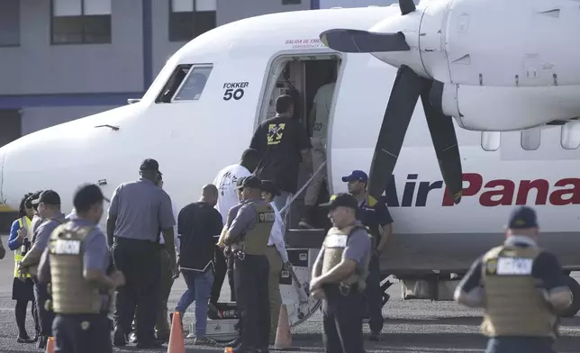 People board a repatriation flight bound for Colombia at Albrook Airport in Panama City, Monday, Feb. 3, 2025. (AP Photo/Mark Schiefelbein, Pool)