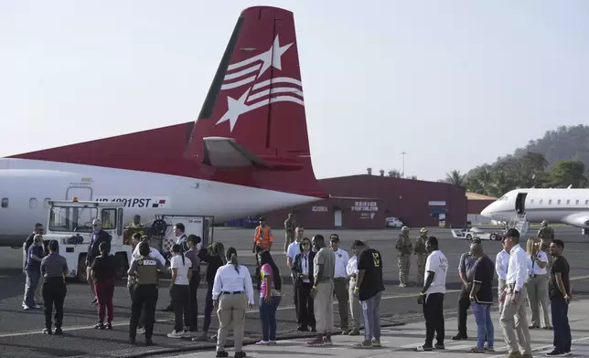 People arrive to board a repatriation flight bound for Colombia at Albrook Airport in Panama City, Monday, Feb. 3, 2025. (AP Photo/Mark Schiefelbein, Pool)