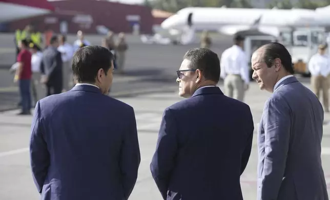 Secretary of State Marco Rubio, left, Frank Alexis Abrego, Panama's Minister of Public Security, center, and Panama's Foreign Minister Javier Martinez-Acha, watch as people board a repatriation flight bound for Colombia at Albrook Airport in Panama City, Monday, Feb. 3, 2025. (AP Photo/Mark Schiefelbein, Pool)